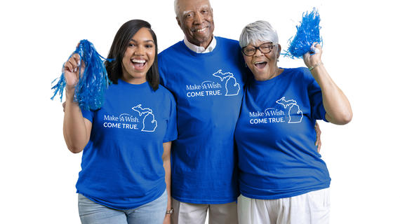 wish family wearing the monthly giving shirts while cheering