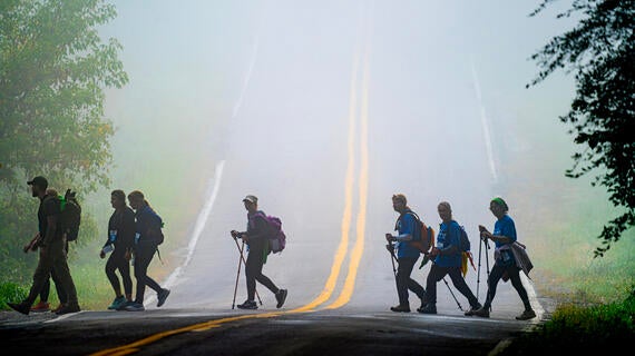 Last year's trailblazers hiking on a path in the foggy morning