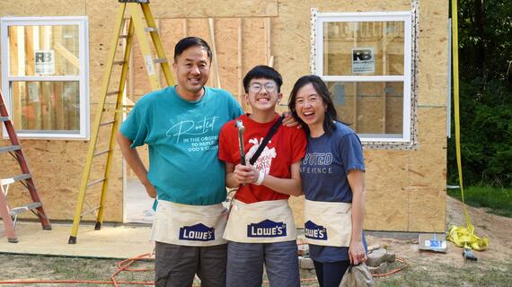 Manny pictured center with his parents on the construction site