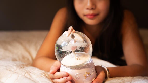 Wish kid Moci looking at a snow globe