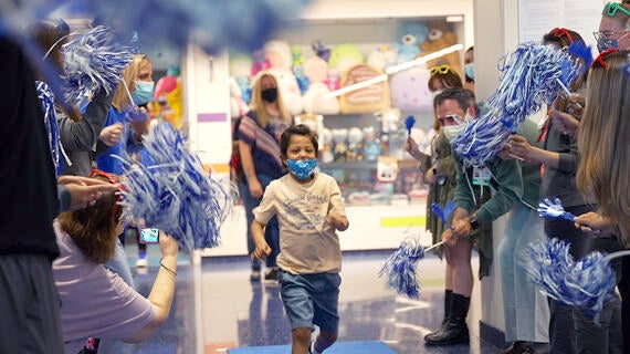 boy running through celebration line at hospital