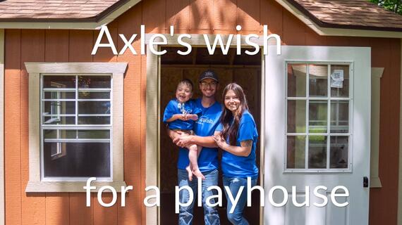 wish family wearing blue shirts outside playhouse
