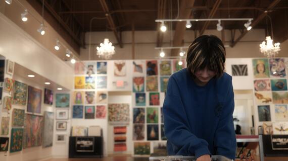 Lucy working on her wish art in a studio