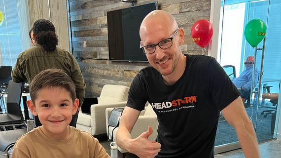 wish kid and employee fundraiser smiling
