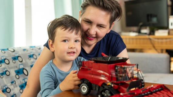 Wish kid Henry playing with combine toy with his mom