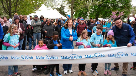 Alicia Smith cutting the ribbon opening the Zoo along with a group of wish kids and Michael Hull