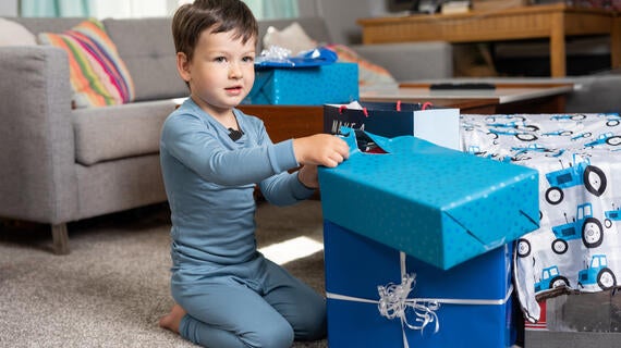 Wish kid Henry opening presents in his living room