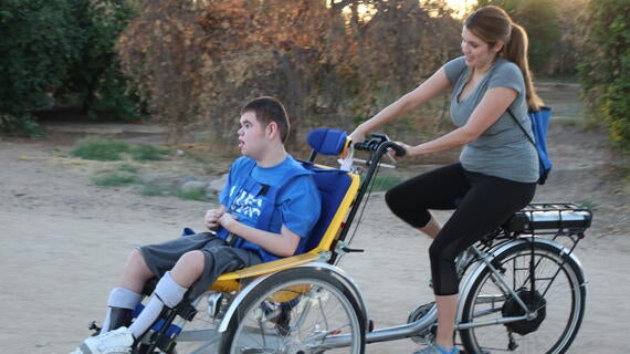 Brendan and his mom on his adaptive tandem bicycle.