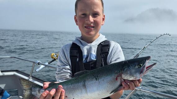 Photo of wish kid holding a fish