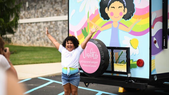 Child in front of camper