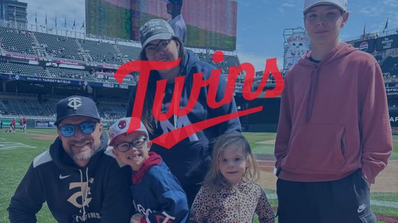 MN Twins logo on top of an image of people at the game