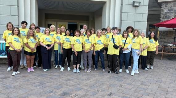 Image shows a group of volunteers posing for a photo