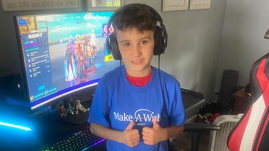 Ian gives a thumbs up in front of his new gaming computer.