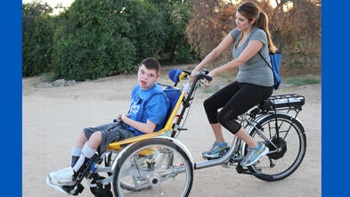 Brendan and his mom Natalie on his new adaptive bike
