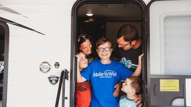 Ethan surrounded by his family in his new camper