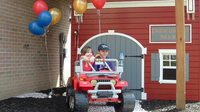 Six-year-old Ezra takes his Fire Rescue Jeep® for a spin around the block.