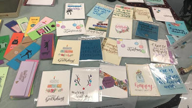 A group of Simran's greeting cards laid out on the table.