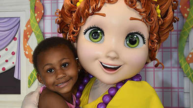 Wish child Taylor hugs a theme park character