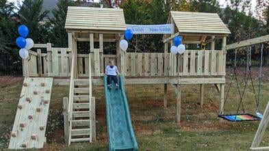Gavin's wish to have an adaptive playset, Gavin on the slide