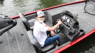 Noah sits at the helm of his new bass fishing boat