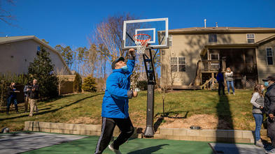 Wish kid Luke playing basketball on his sport court