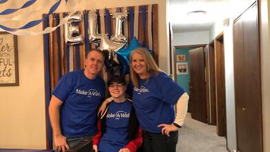 Elijah and his family smile for the camera the day his wish is granted.
