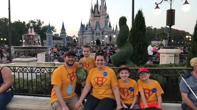 Henry and his family pose in front of Cinderella's Castle at Magic Kingdom.