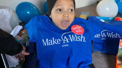 Khami, in his Make-A-Wish shirt, sits in his camper for the first time.