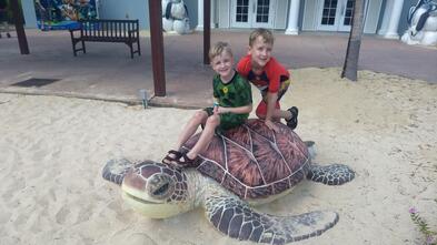 Liam on a turtle statue at the beach
