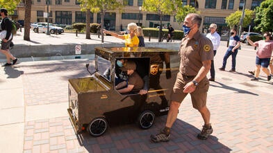 Mateo in his UPS Truck with UPS Driver Dave and Chapter President and CEO Jennifer Stolo in tow