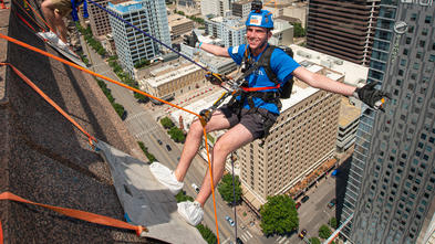 Wish kid Sam rappelling at Over The Edge.