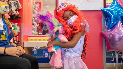 Amina hugging doll