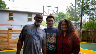 Solomon and his parents on the basketball court.