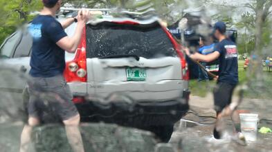 Two men wash a station wagon