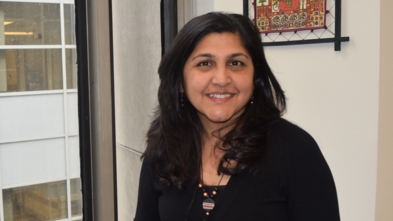 Dr. Peddinti smiling in her office