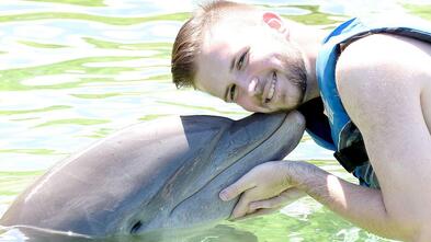 Patrick swimming with dolphin