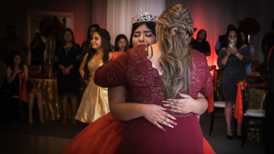 Emely cries as she dances with her mother