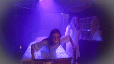scary woman on bed in haunted house