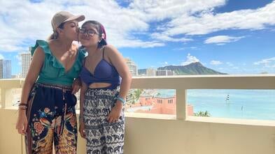 wish kid Abby and their mom on the balcony of their hotel in Hawaii