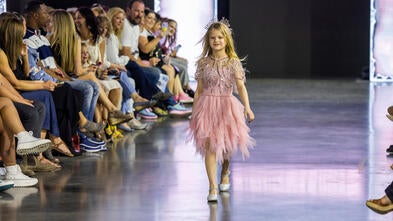 Lucy walks in a fashion show