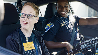 Wish kid Johnny in police car with Indiana State Police