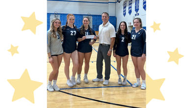 Blue Mountain Volleyball Boosters players with  Make-A-Wish volunteer presenting their donation.