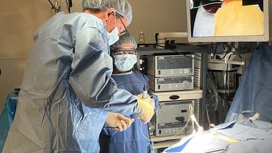 Melanie and Professor of Gastrointestinal Surgery, Dr. Eric Hungness in the Northwestern University Feinberg School of Medicine simulation lab performing a gallbladder removal.
