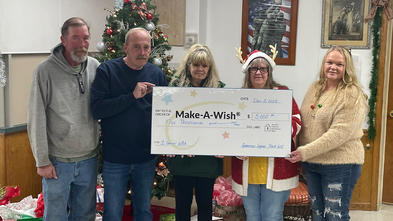 American Legion Post 612 members hold up it's donation to wishes in 2023.