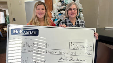 Naley McKamish, director of marketing presenting a $65,388 donation to Stephanie Pugliese, Make-A-Wish Director of Development.