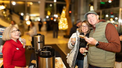 Stephanie serves hot chocolate to a happy couple. 