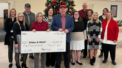  Pictured is the DMI Make-A-Wish Committee with CEO, Ray Yeager presenting Stephanie Pugliese, Make-A-Wish director of development.