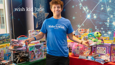 wish kid Jude with a lot of presents behind him