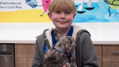 Jace holding Luna, his French bulldog puppy