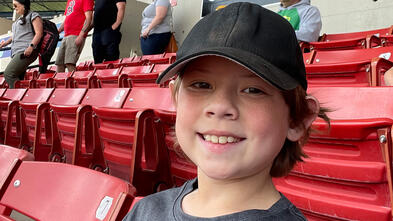 Seton sitting in a stadium — AKWA